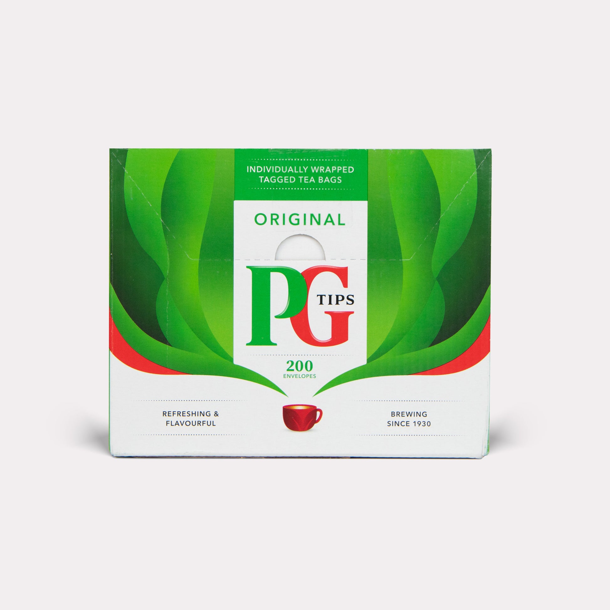 PG Tips tea box with green leaves and red accents on a white background