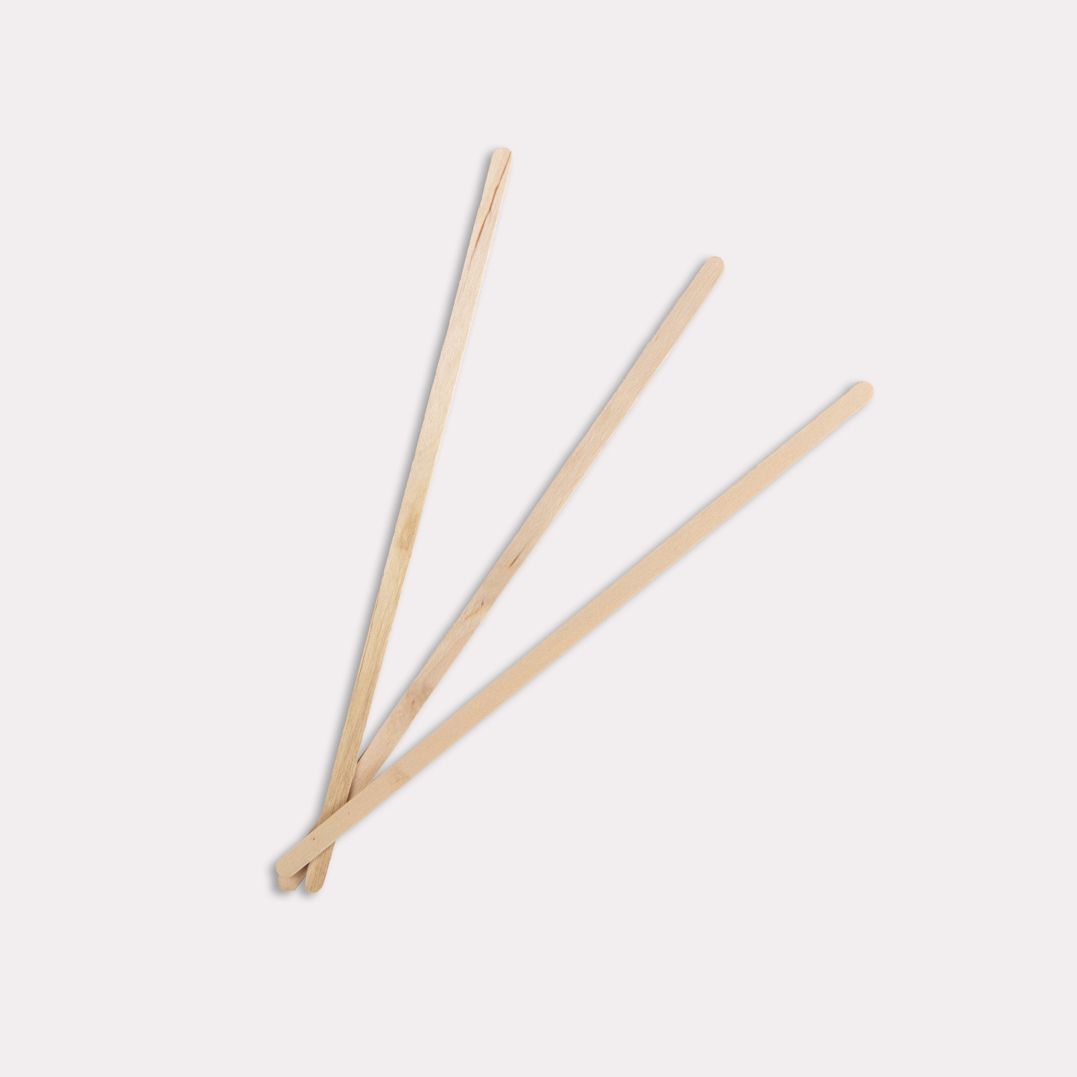 Three wooden sticks on a white background